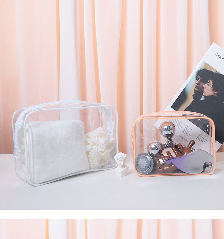 Two PVC transparent makeup bags in white and peach, one holding cotton pads and the other containing beauty tools, displayed on a white surface with a soft peach curtain background.